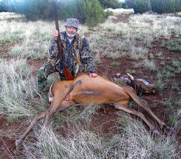 Miles with the last cow elk he harvested. He wrote the hunting trip up for Muzzle Blasts magazine.